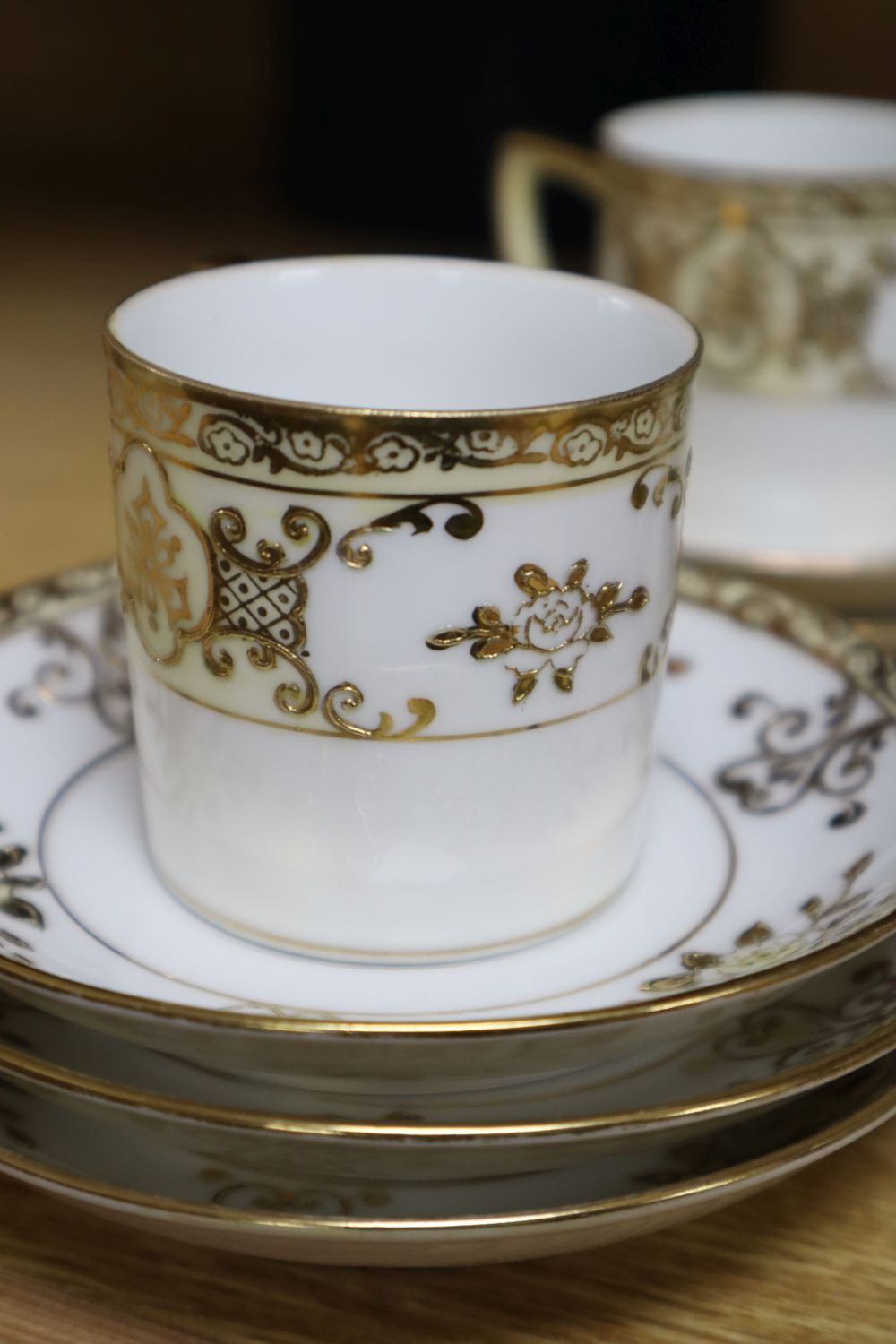 A set of six Royal Crown Derby miniature tea cups and saucers, date codes 1920s and a Noritake fifteen piece coffee service